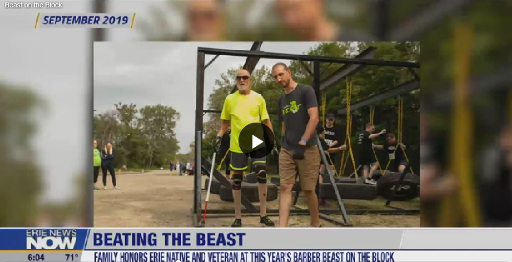 A screenshot of an Erie News Now segment titled "Beating the Beast." Two men are standing in front of a tire obstacle course